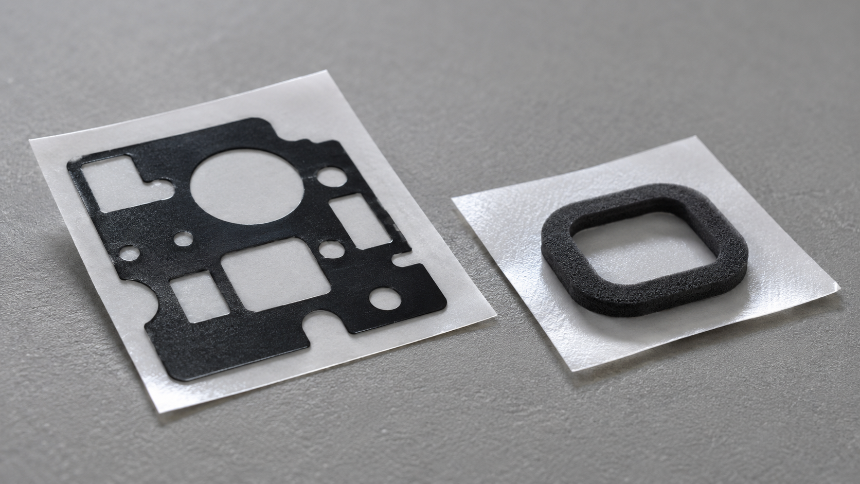 Black PET adhesive die-cut component and foam gasket showing realistic edge construction