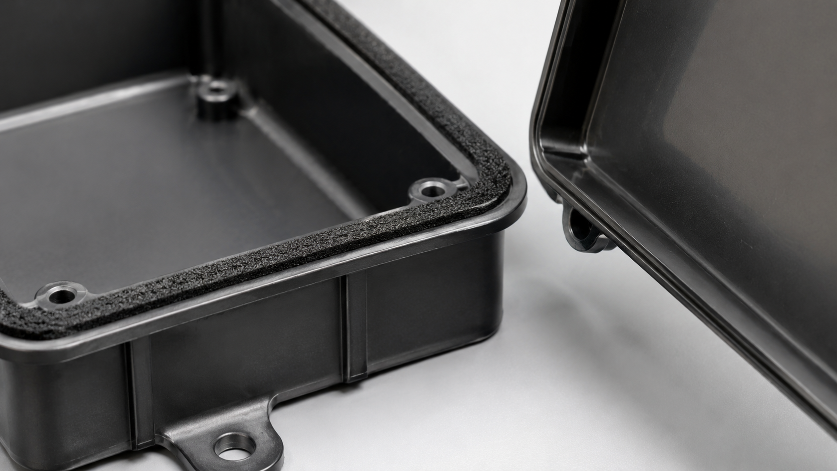 Custom foam gasket positioned between electronic enclosure components for controlled compression and sealing