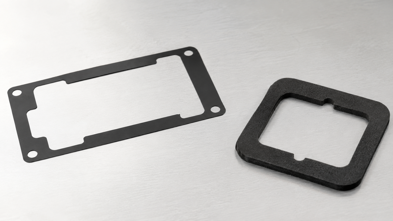 Black PET adhesive frame and foam gasket showing internal openings, narrow borders and die-cut geometry