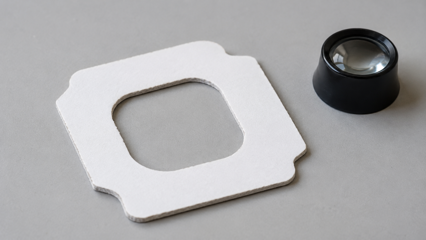 Quality inspection of one die-cut paper sample on a clean engineering surface