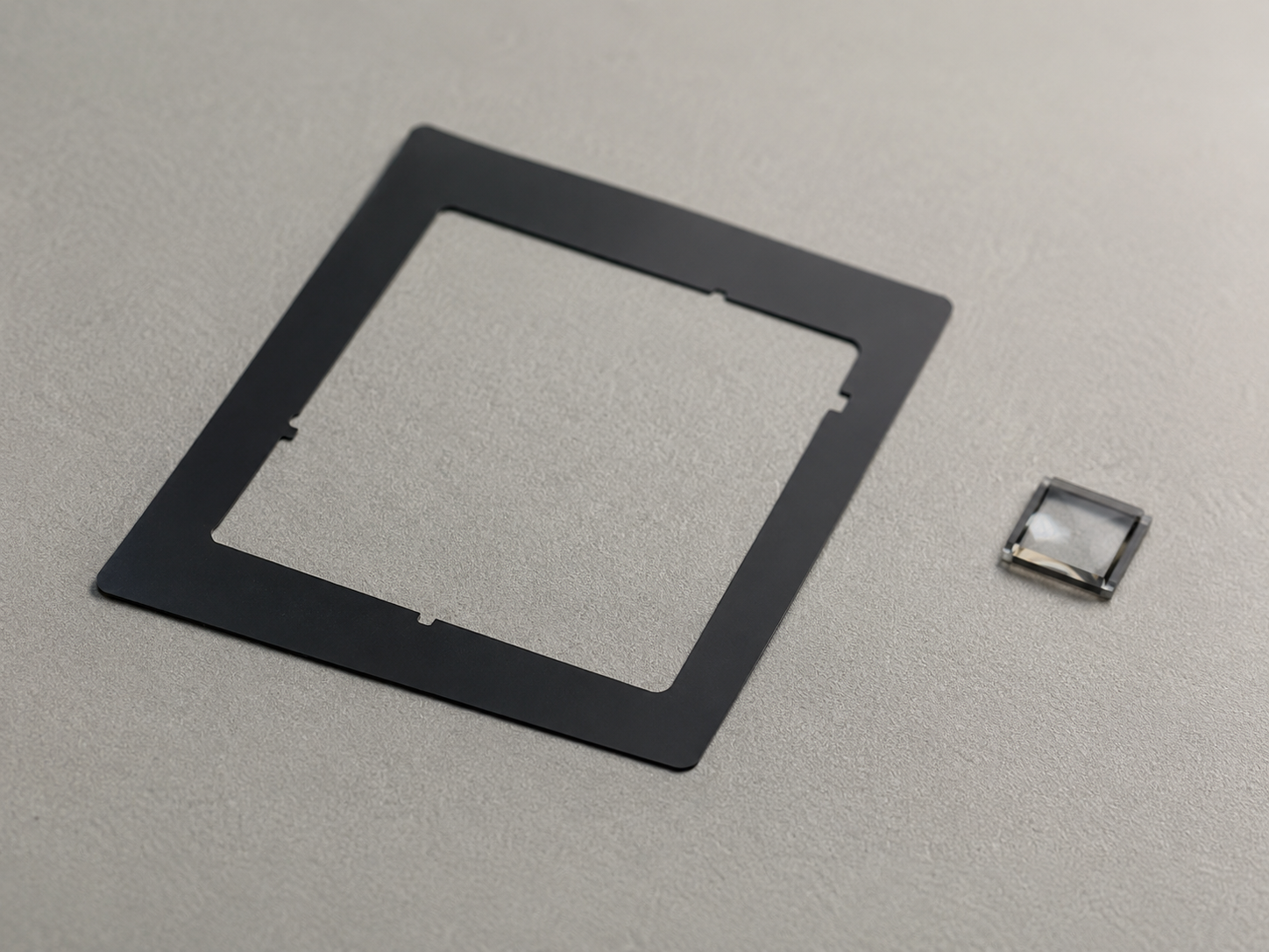 Image Description: Realistic industrial photography showing precision die cut black light-blocking films, black PET film components, adhesive-backed optical film parts, release liners, inspection tools, digital calipers, and clean OEM workbench setup for optical and electronic component manufacturing. No displays, complete devices, text, labels, logos, arrows, or icons. Image width: 1600–1920 px. Target file size: 100–200 KB.